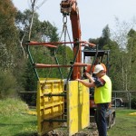 Standard Shield with handrails being guided into trench on work site