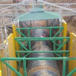 High clearance speader bars allowing trench shoring around a large diameter pipe.